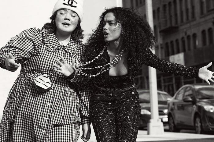 Two young women walking in a city street