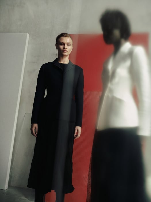 Two women in formal clothes standing in a room