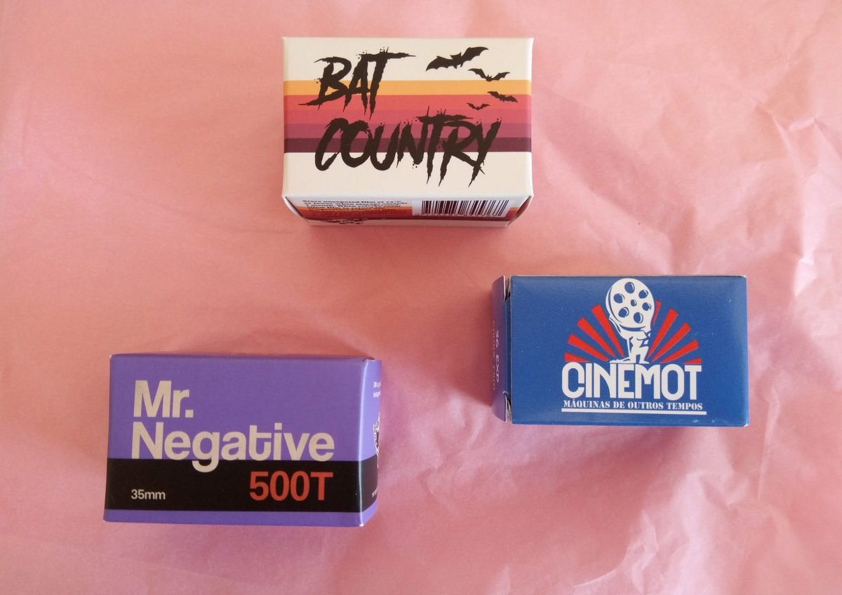 Three film stock boxes on pink paper