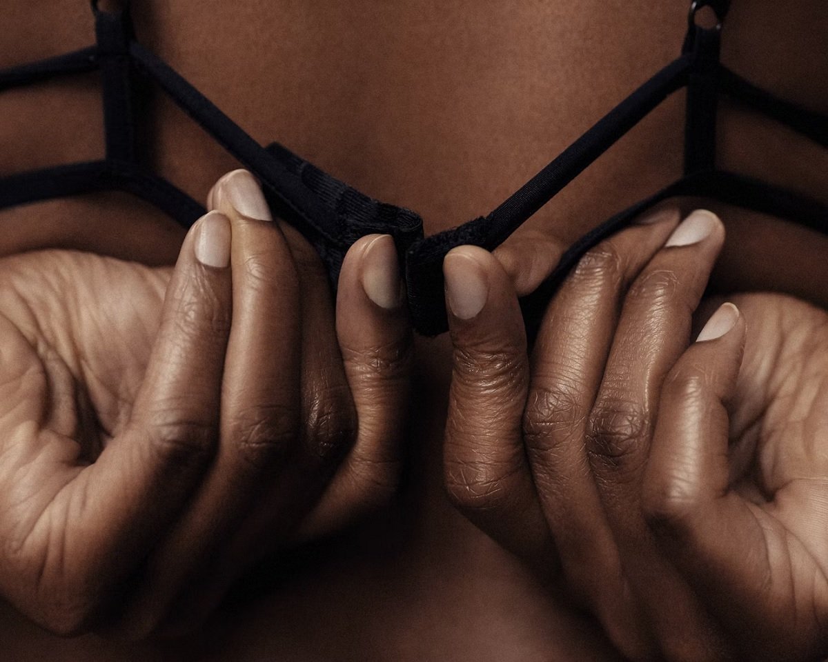 Close up of woman undoing bra
