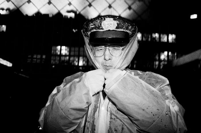 Street portrait of policeman in rain poncho