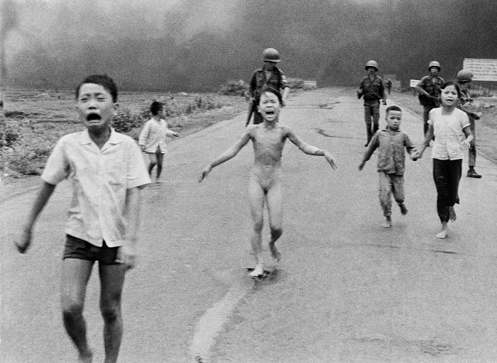 Children crying while fleeing burning village in Vietnam
