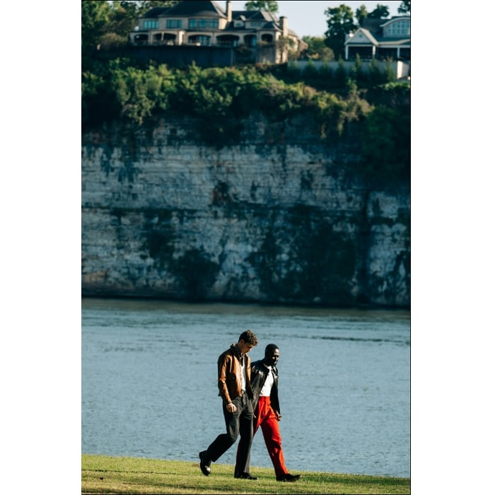 Two men talking by a river