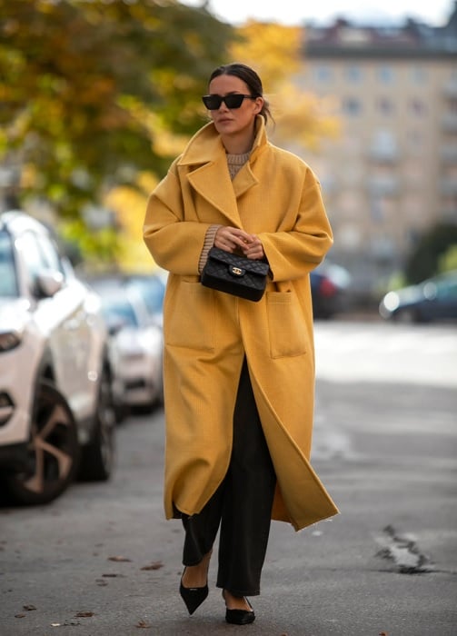 Woman in yellow coat in city street