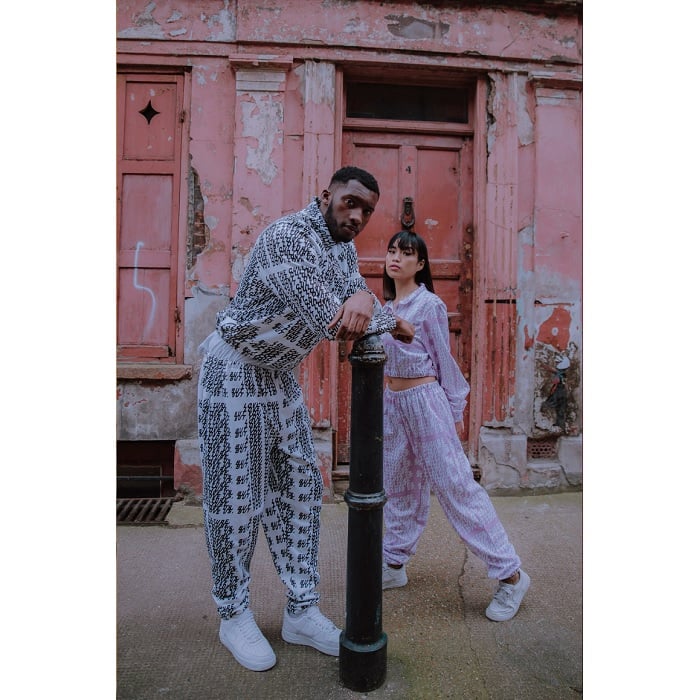 Man and woman in front of an old red doorway