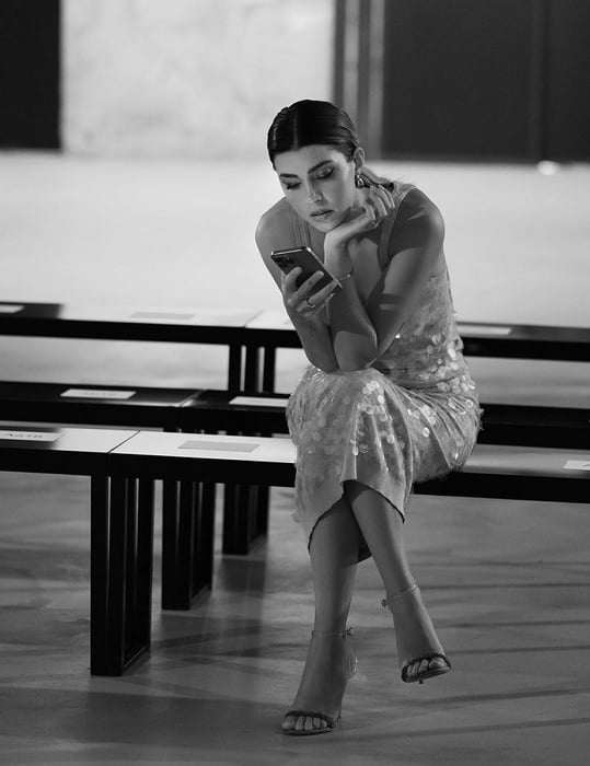 Woman in elegant dress looking at her phone