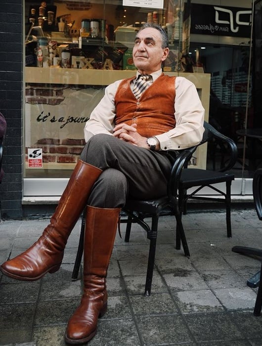 Man on seat in semi formal clothes and riding boots