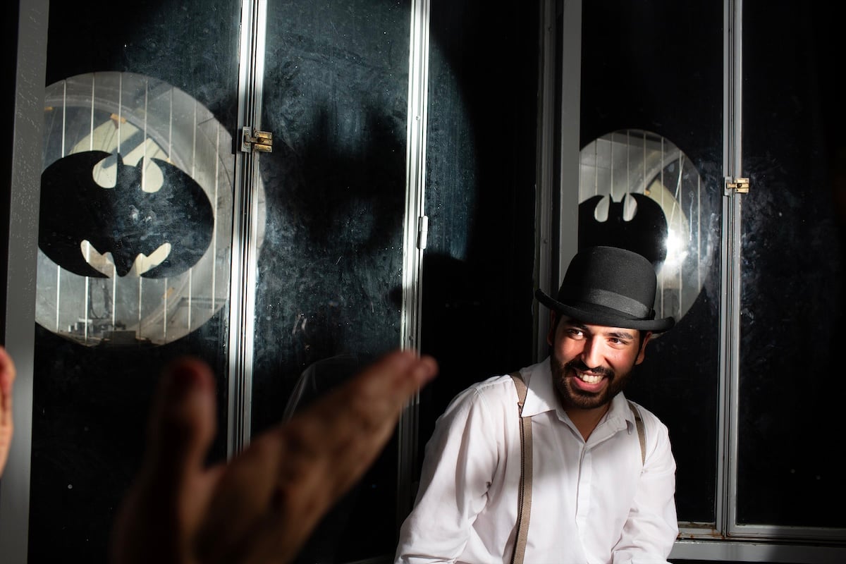 image of man on stage with bowler hat edited in lightroom