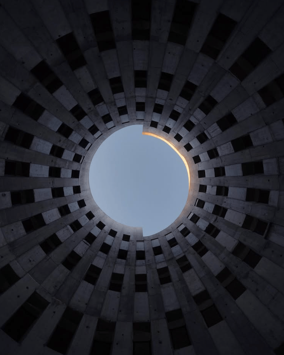 photo taken in the middle of building looking up at the sky