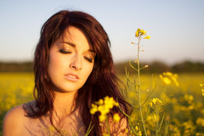 Outdoor portrait of a female model in a field of flowers