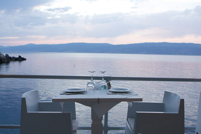 Une table à manger extérieure au bord de la mer à la lumière naturelle