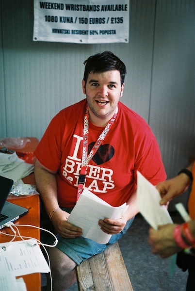 A man in a red t-shirt stares at the camera - Window Light for Portraits