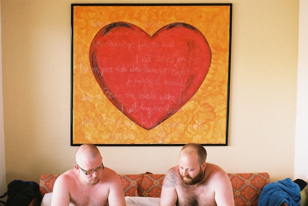 Two men sit under a huge, red heart - Window Light for Portraits