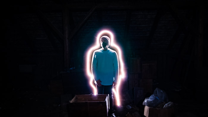 Creative portrait of a man lit with a light stick