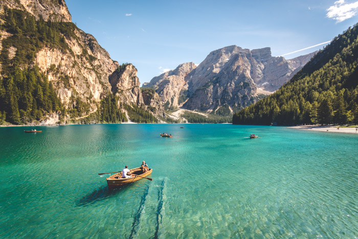 Fanes-Senes-Braies nature park.  Couple boating on a lake with mountains in the distance.