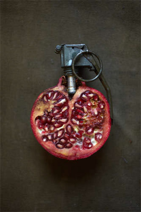 Giuseppe Colarusso still life justaposition photography of a pomegranate with grenade pin . Photography justaposition examples.