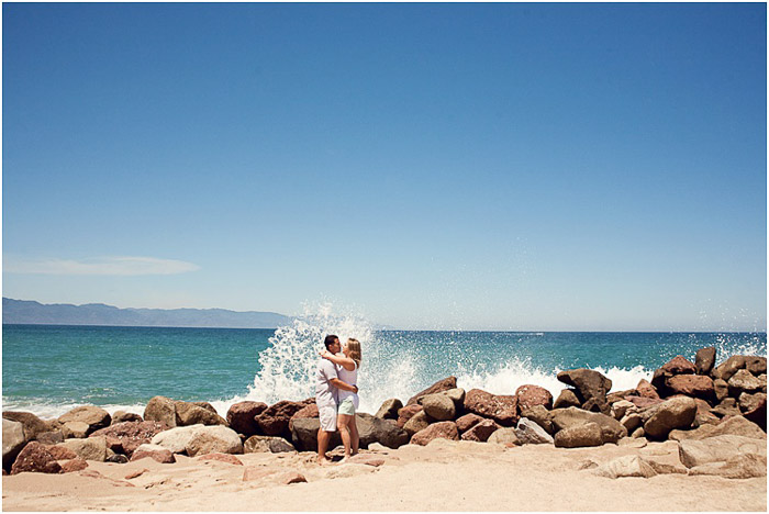 Beautiful engagement photography shot of a couple embracing on a beach