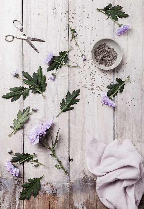 Still life photography of lavender and flowers on wooden boards, overhead shot. 