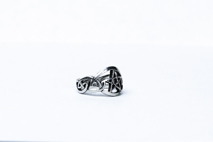 A product shot of a small silver ring 