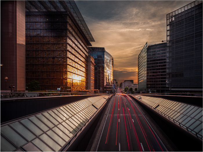 Urban scene with many light trails going straight ahead on a highway