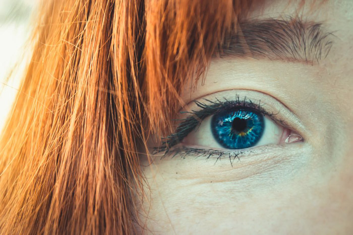 a close up picture of a female models blue eyes