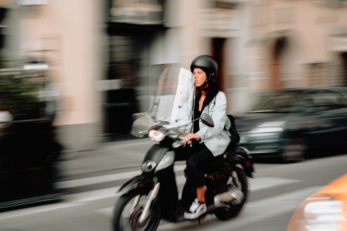 Photo of a girl on a motorbike with motion blur