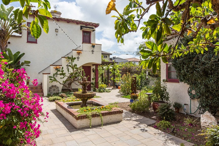 photo of a mediterranean style garden with flowers and trees