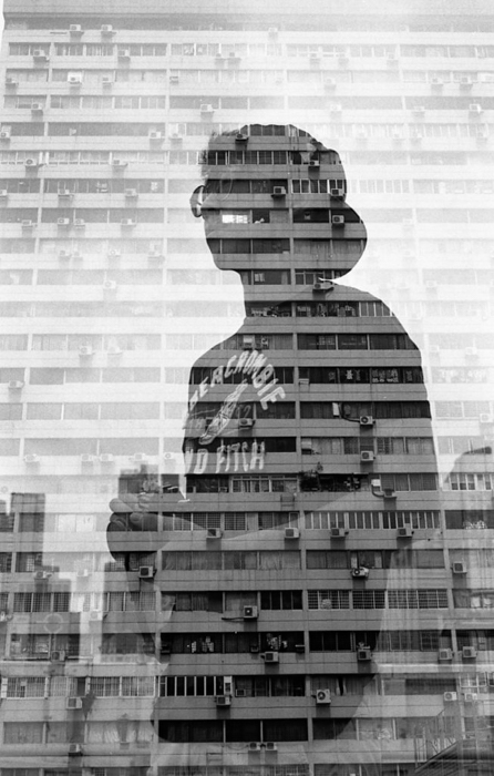 Retrato duplamente exposto de um homem e um edifício de vários andares 