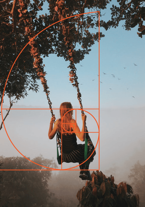 A photo of a girl on a swing overlayed with golden ratio composition grid