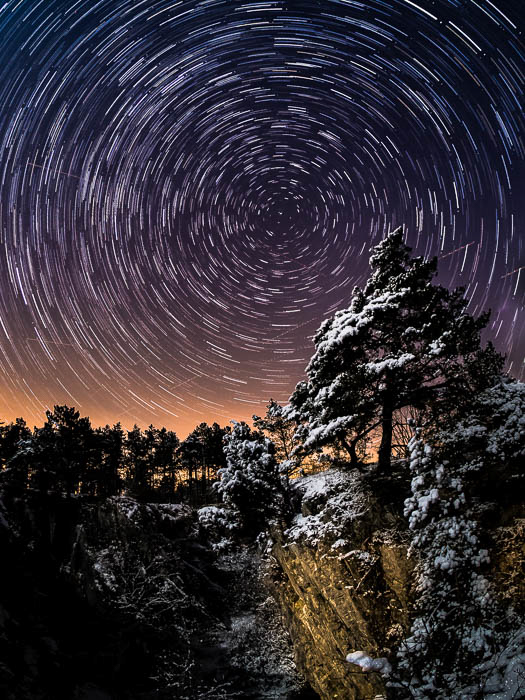 Uma foto impressionante de trilhas de estrelas no céu noturno.