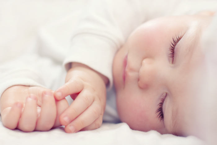 Close-up dari tangan dan wajah bayi
